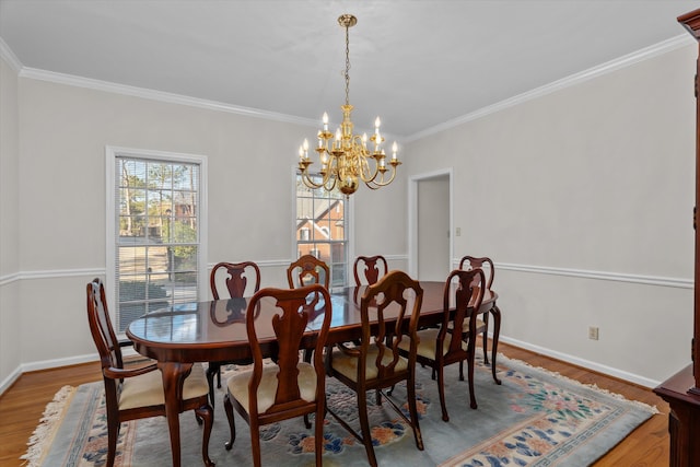 dining room with crown molding, hardwood / wood-style floors, and a chandelier