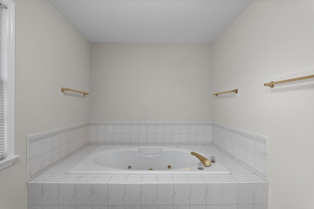 bathroom featuring tiled tub