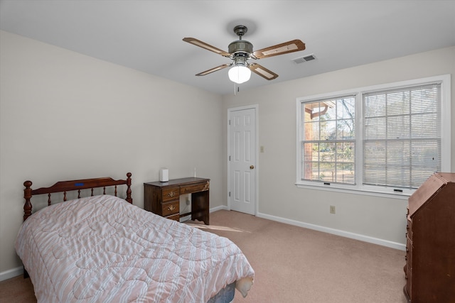 bedroom with light carpet, multiple windows, and ceiling fan