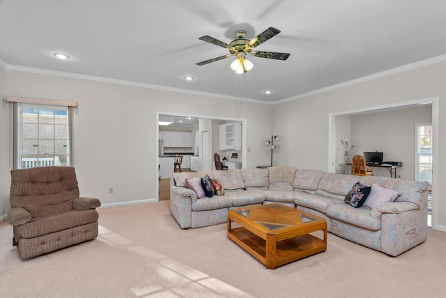 living room featuring ceiling fan, ornamental molding, and carpet floors