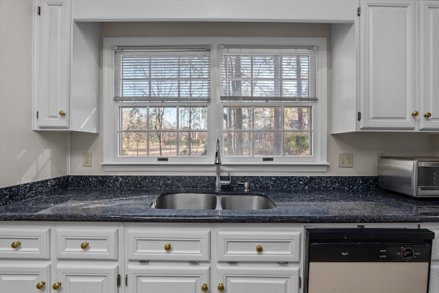 kitchen featuring a wealth of natural light, dishwasher, sink, and white cabinets