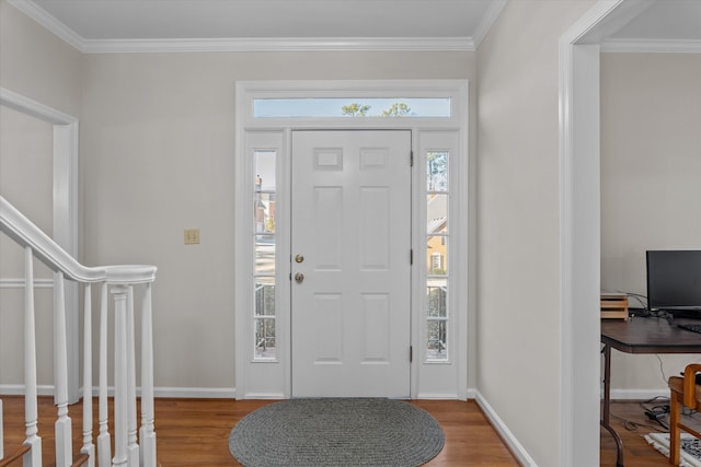 foyer with ornamental molding and hardwood / wood-style floors