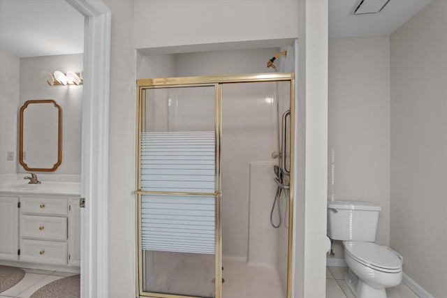 bathroom featuring walk in shower, vanity, toilet, and tile patterned flooring