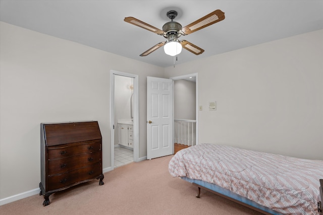 carpeted bedroom with ensuite bathroom and ceiling fan