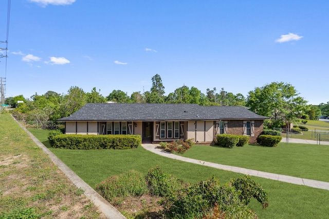 single story home featuring fence and a front yard
