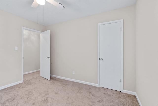 unfurnished bedroom featuring ceiling fan, carpet floors, and baseboards