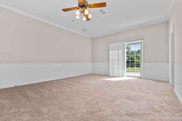empty room with visible vents, carpet flooring, and crown molding