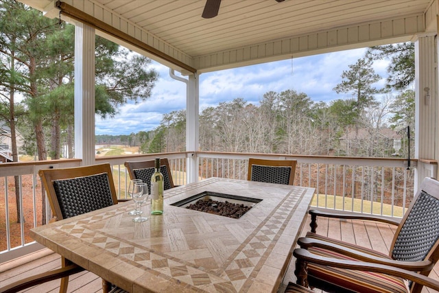 deck with ceiling fan and an outdoor fire pit