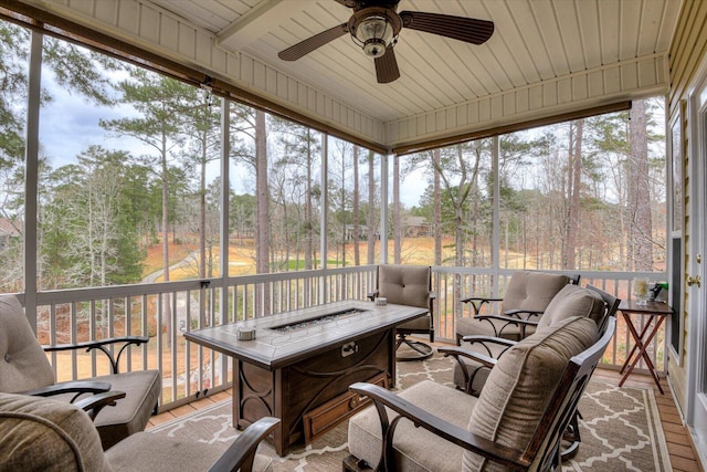 sunroom featuring ceiling fan and plenty of natural light