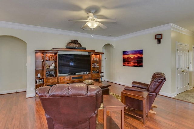 living room with ceiling fan, crown molding, and light hardwood / wood-style flooring