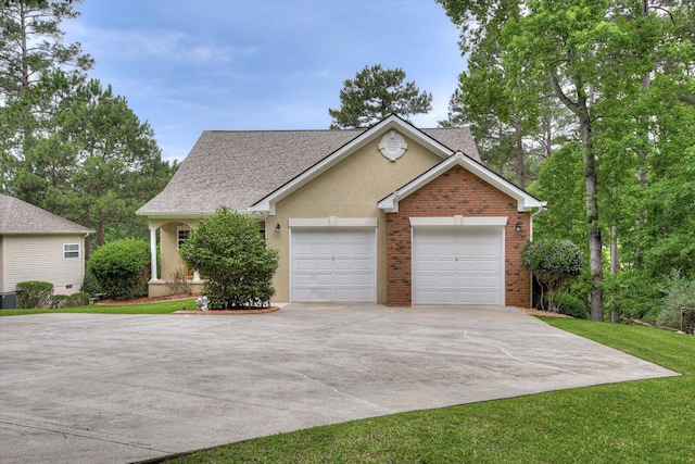 view of front of property featuring a garage and cooling unit