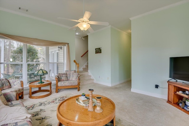 living room with ceiling fan, light colored carpet, and ornamental molding