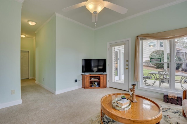 living room with carpet, a wealth of natural light, ceiling fan, and crown molding