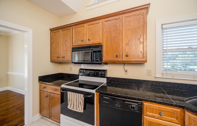 3701 Wexford Dr, Martinez, GA 30907 - kitchen with black appliances, brown cabinets, and dark stone countertops