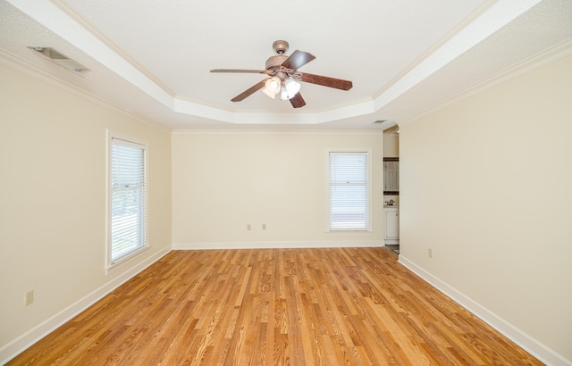 3701 Wexford Dr, Martinez, GA 30907 - spare room featuring a tray ceiling, ornamental molding, plenty of natural light, and light wood-type flooring
