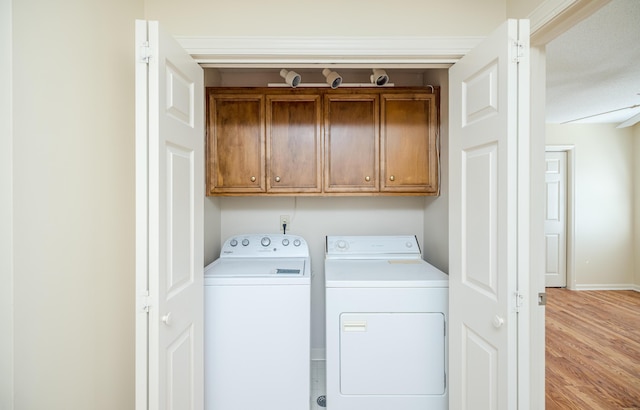 3701 Wexford Dr, Martinez, GA 30907 - laundry room featuring cabinet space, washing machine and clothes dryer, and light wood-style flooring