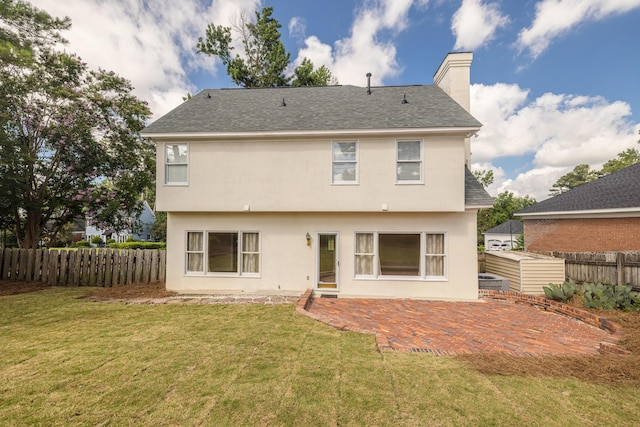 3701 Wexford Dr, Martinez, GA 30907 - rear view of house with stucco siding, a chimney, roof with shingles, and a patio