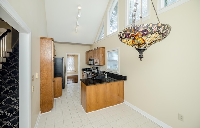 3701 Wexford Dr, Martinez, GA 30907 - kitchen with black range with electric stovetop, freestanding refrigerator, brown cabinetry, light tile patterned flooring, and high vaulted ceiling