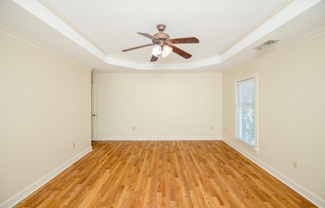 3701 Wexford Dr, Martinez, GA 30907 - spare room featuring a tray ceiling, a ceiling fan, light wood-type flooring, and crown molding