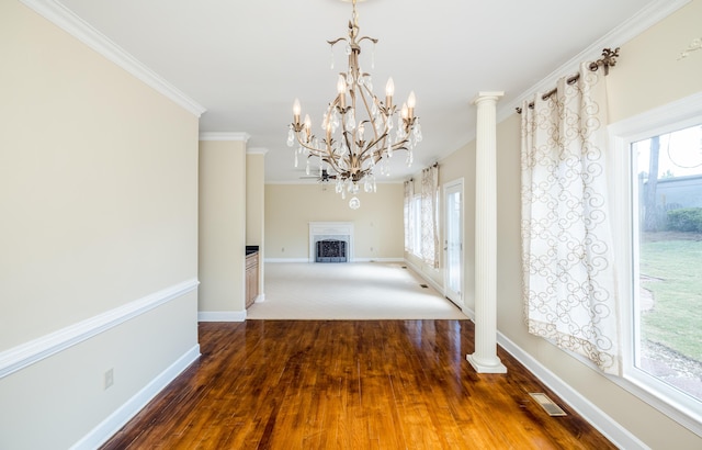 3701 Wexford Dr, Martinez, GA 30907 - unfurnished dining area with a fireplace, wood finished floors, crown molding, and a chandelier
