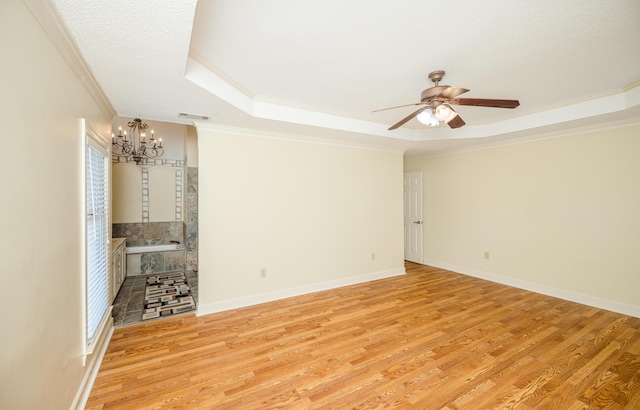 3701 Wexford Dr, Martinez, GA 30907 - unfurnished living room featuring a raised ceiling, ornamental molding, a chandelier, ceiling fan, and light wood-style flooring