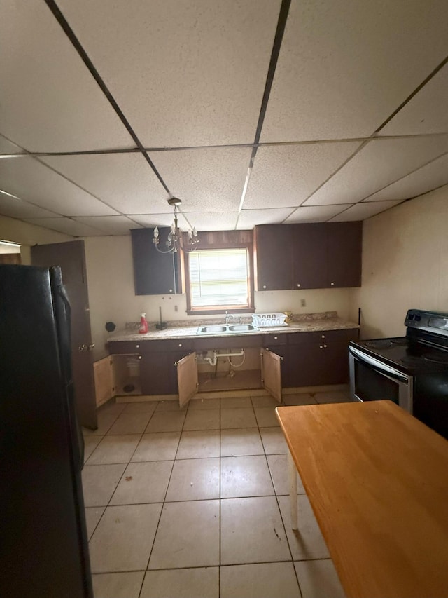 205 Addison St, Johnston, SC 29832 - kitchen featuring electric stove, freestanding refrigerator, a sink, light countertops, and a paneled ceiling