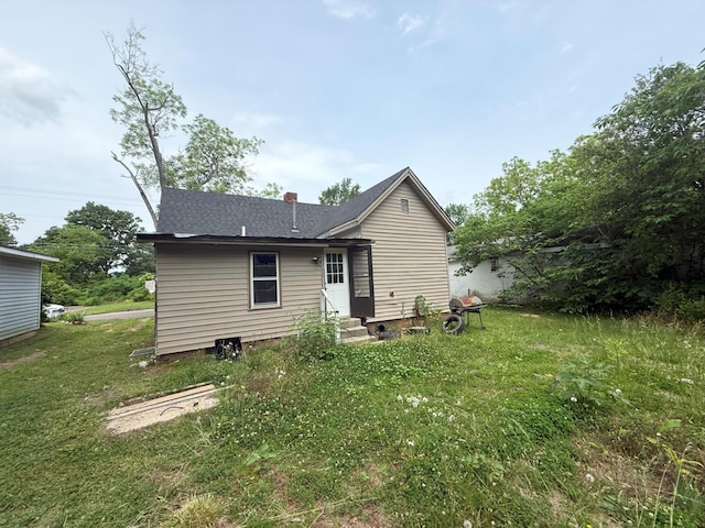 205 Addison St, Johnston, SC 29832 - back of house with entry steps, a yard, roof with shingles, and a chimney