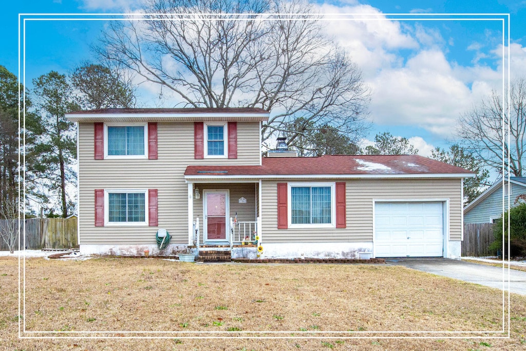 front of property featuring a garage and a front yard