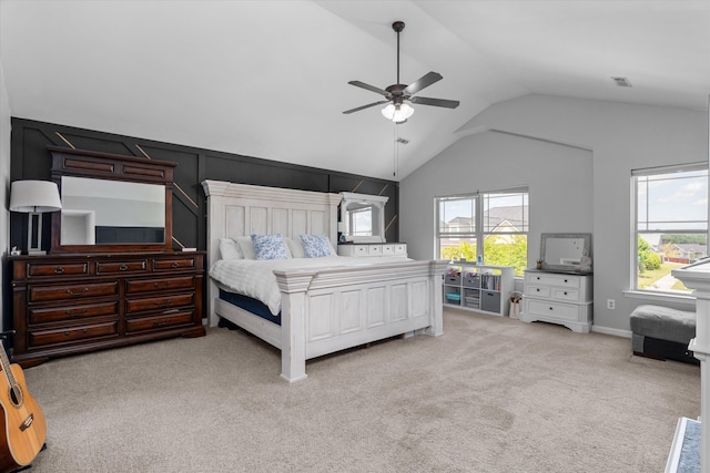 carpeted bedroom with a ceiling fan, visible vents, multiple windows, and lofted ceiling