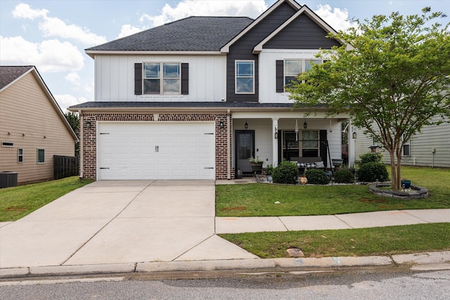 craftsman-style home with driveway, board and batten siding, an attached garage, a front lawn, and covered porch