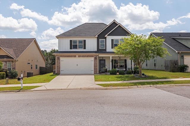view of front of property with a front yard, a porch, fence, brick siding, and driveway