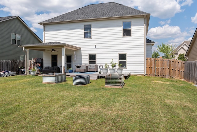 back of house with a fenced backyard, ceiling fan, a lawn, and an outdoor hangout area