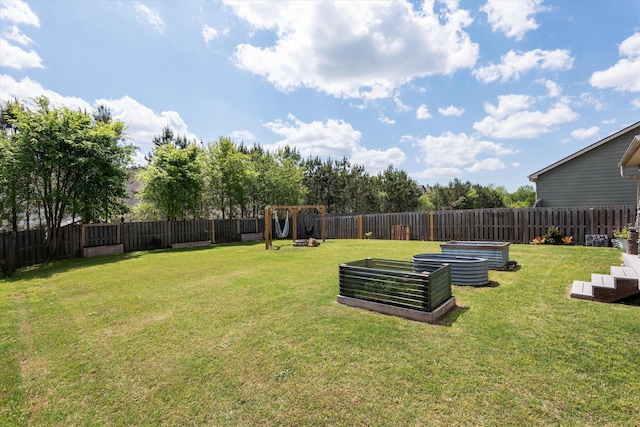 view of yard featuring a garden and a fenced backyard
