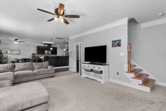 living room featuring crown molding, ceiling fan, and light carpet