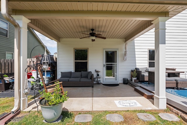 view of patio / terrace with an outdoor living space, fence, and ceiling fan