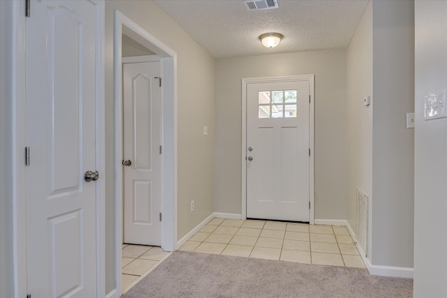 3650 Crawfordville Dr, Augusta, GA 30909 - foyer entrance featuring light tile patterned floors, a textured ceiling, and light carpet