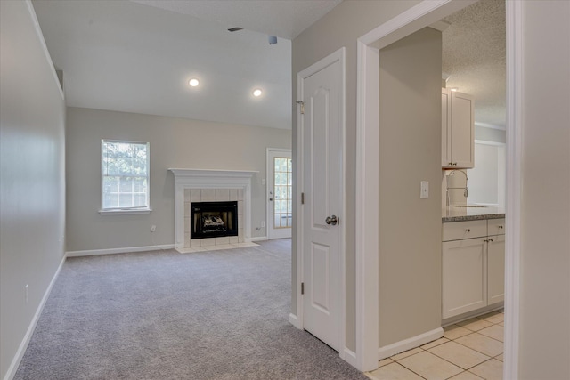 3650 Crawfordville Dr, Augusta, GA 30909 - unfurnished living room featuring plenty of natural light, a fireplace, light carpet, and recessed lighting