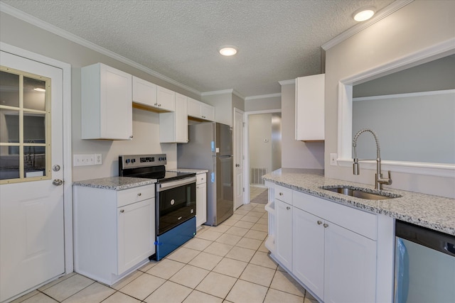 3650 Crawfordville Dr, Augusta, GA 30909 - kitchen featuring appliances with stainless steel finishes, white cabinetry, light tile patterned flooring, a textured ceiling, and light stone counters