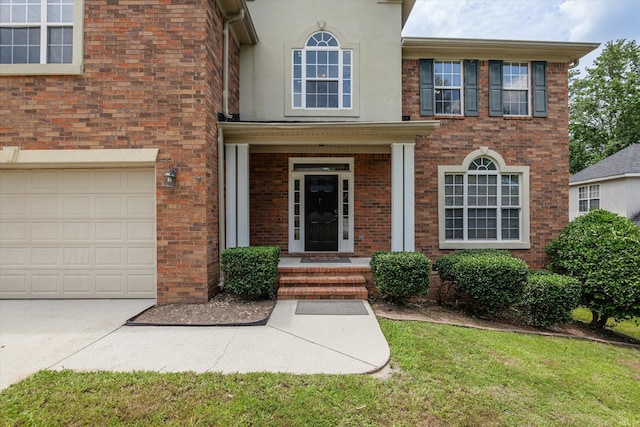 1094 Hampstead Pl, Martinez, GA 30907 - view of front facade with brick siding, an attached garage, driveway, and stucco siding