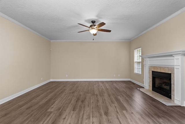 1094 Hampstead Pl, Martinez, GA 30907 - unfurnished living room with a ceiling fan, dark wood-style flooring, a fireplace, crown molding, and a textured ceiling