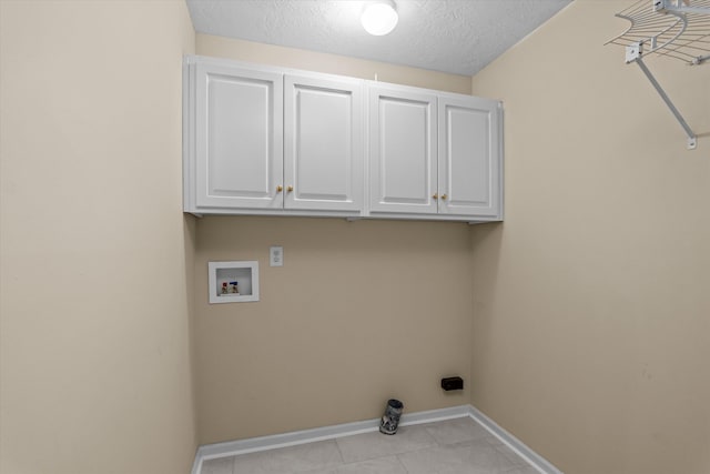 1094 Hampstead Pl, Martinez, GA 30907 - laundry room with cabinet space, washer hookup, a textured ceiling, and light tile patterned floors