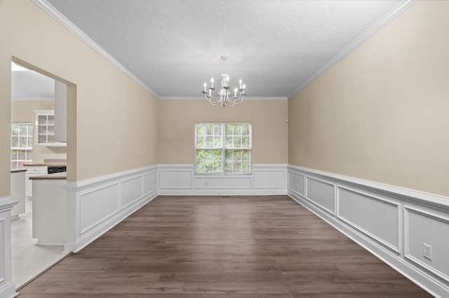 1094 Hampstead Pl, Martinez, GA 30907 - unfurnished dining area with a chandelier, ornamental molding, dark wood-style flooring, a wainscoted wall, and a textured ceiling