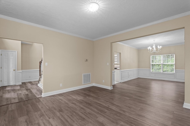 1094 Hampstead Pl, Martinez, GA 30907 - spare room with wood finished floors, crown molding, a chandelier, a wainscoted wall, and a textured ceiling