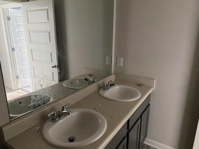 bathroom with a sink and double vanity