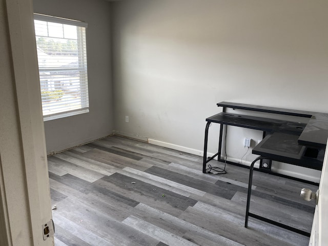 office area with baseboards and wood finished floors