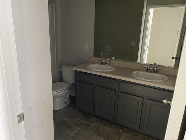 full bath featuring a sink, toilet, and double vanity