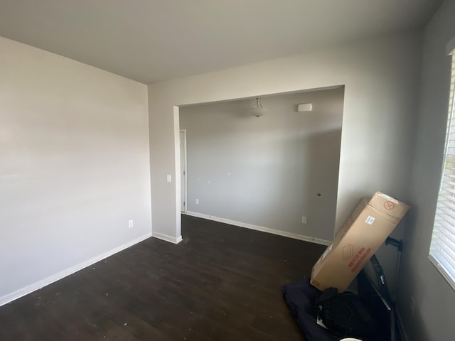 empty room with wood finished floors and baseboards