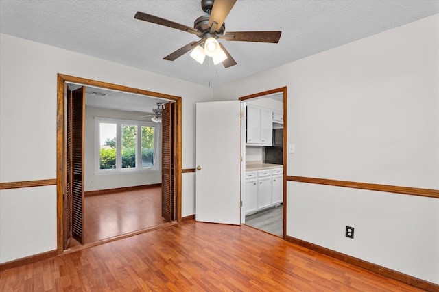 172 Creek View Ct, Martinez, GA 30907 - empty room with light wood finished floors, a ceiling fan, and a textured ceiling