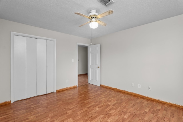 172 Creek View Ct, Martinez, GA 30907 - unfurnished bedroom with light wood-style floors, a closet, ceiling fan, and a textured ceiling