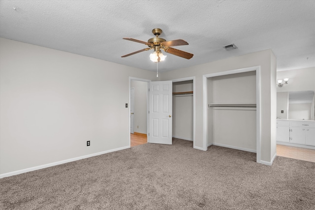 172 Creek View Ct, Martinez, GA 30907 - unfurnished bedroom featuring light carpet, two closets, a textured ceiling, a ceiling fan, and ensuite bath